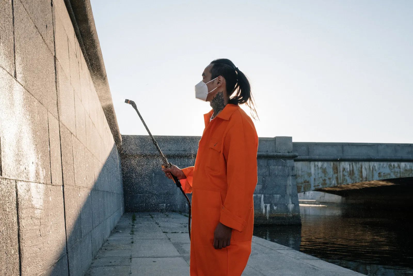 A technician treating the exterior wall of a building